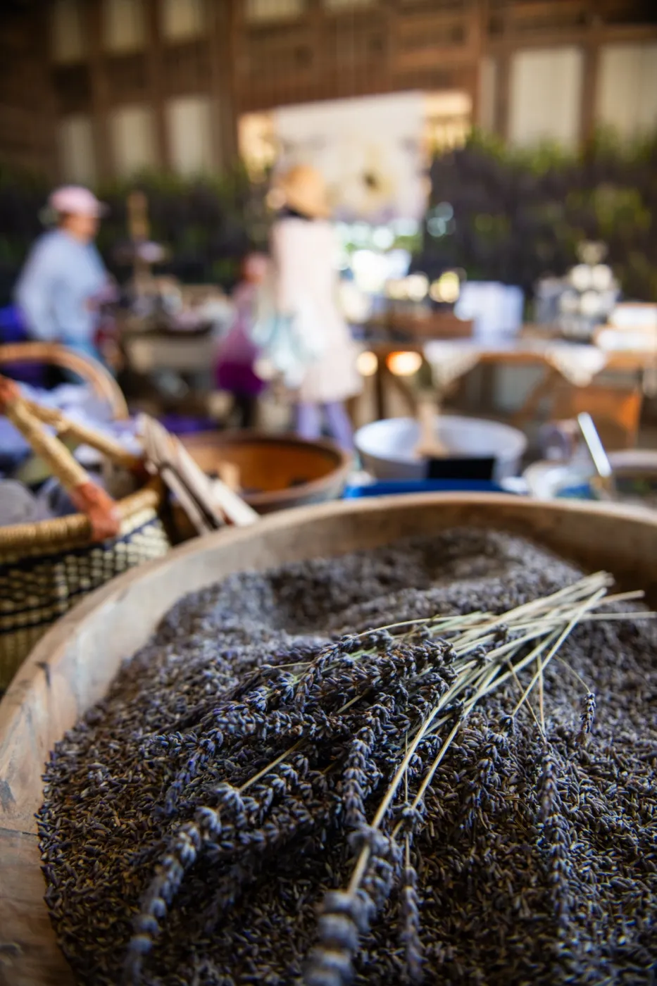 Dried lavender resting in wide wooden bowls inside the barn