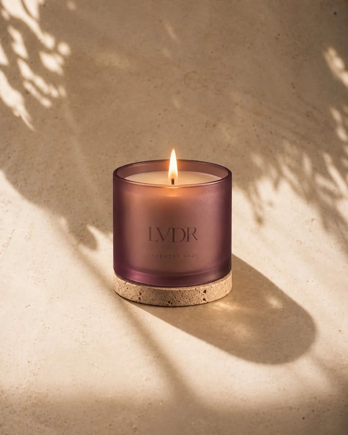 LVDR Lavender Haze candle in frosted violet glass with a travertine lid