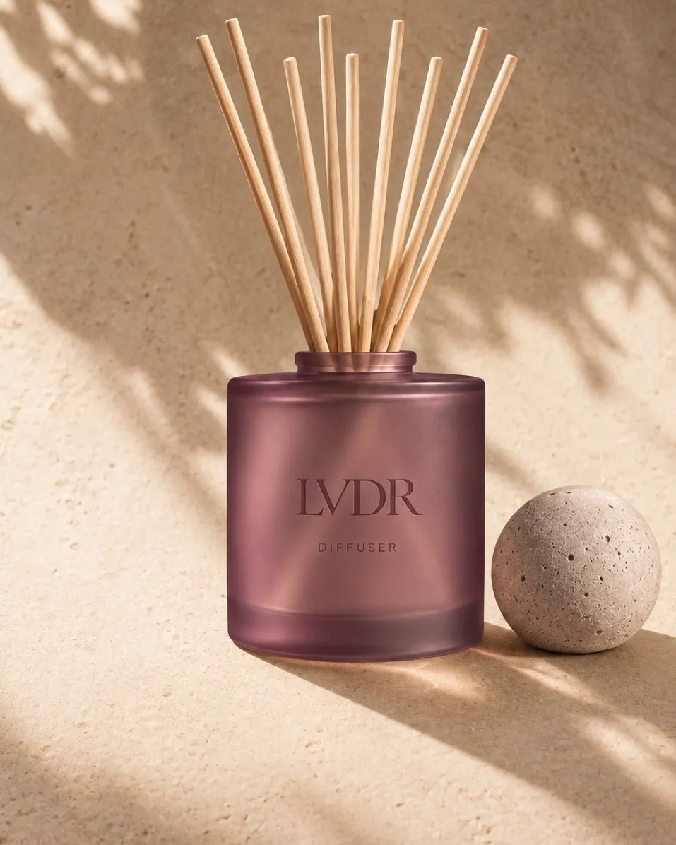 LVDR Lavender Haze reed diffuser in frosted violet glass with a travertine sphere