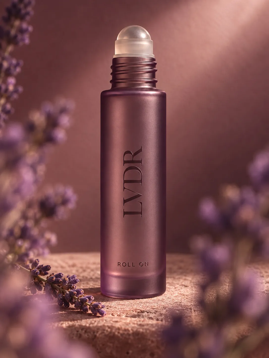 The Lavender Haze roll-on on travertine with fresh lavender